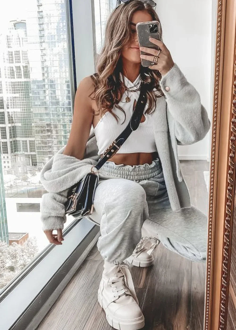 Light grey brushed knit set with white crop top and black shoulder bag.