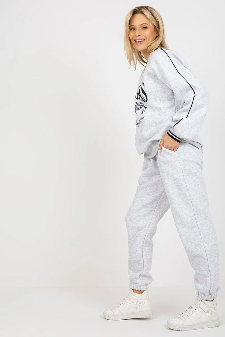 Light gray sweatpants with a drawstring waist and black stripe accents on the legs, shown on a model.