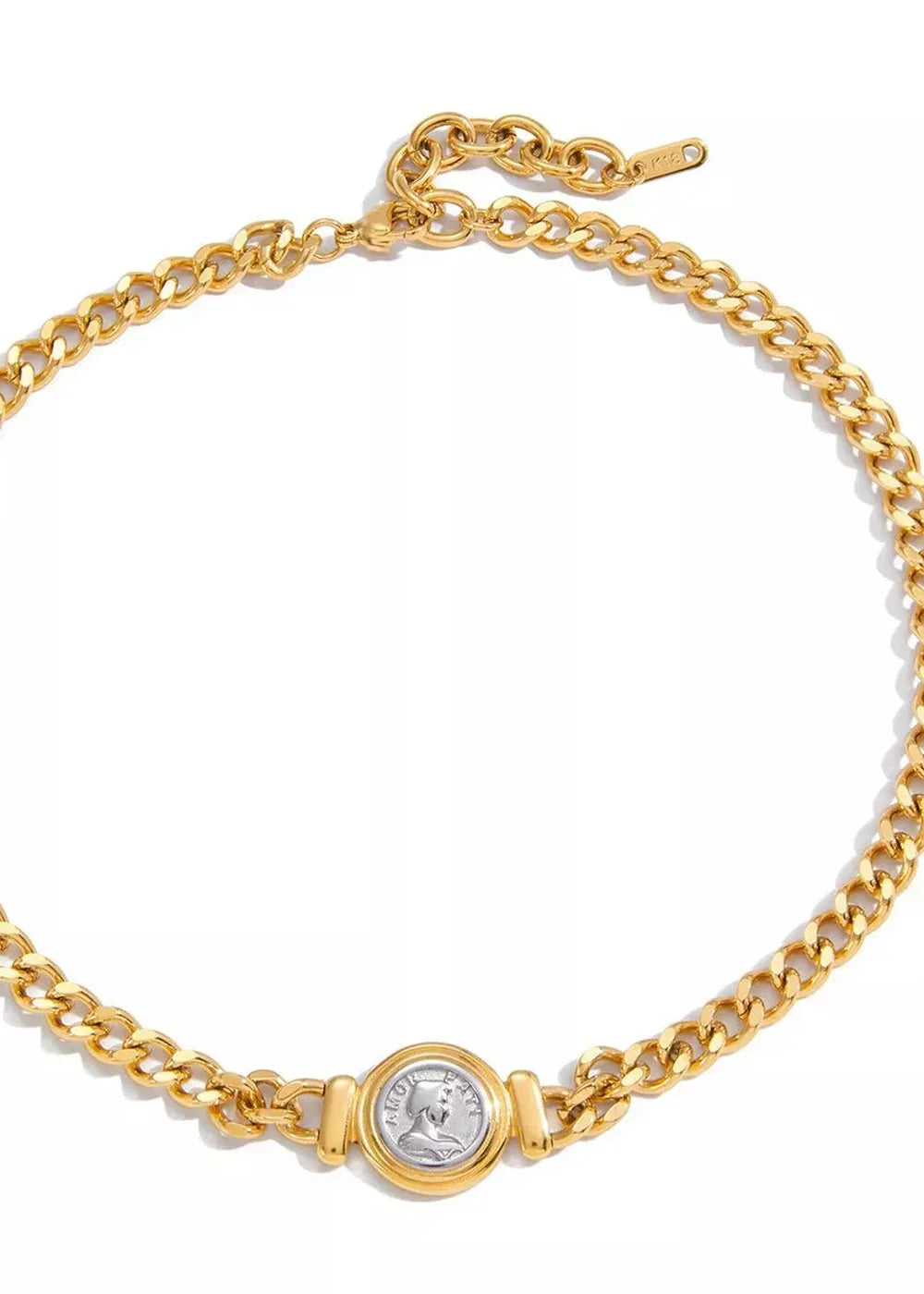 Gold curb chain necklace with a silver-tone coin pendant, detailed texture.