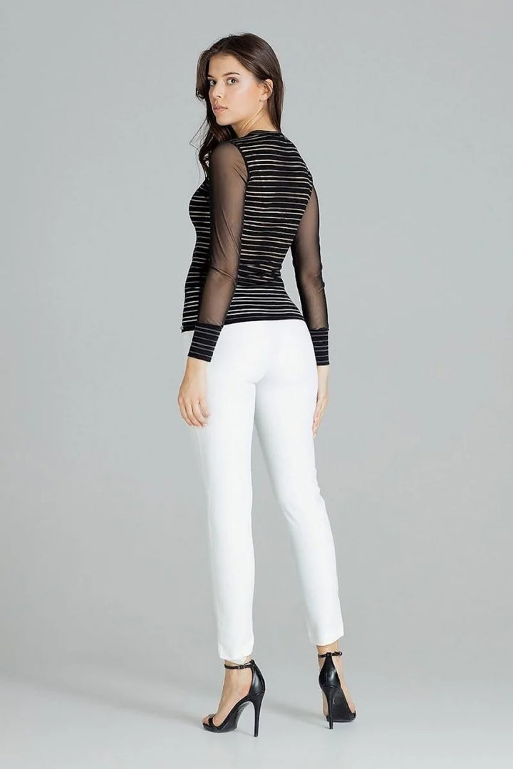 Black and white striped fitted top with sheer long sleeves worn by a model.