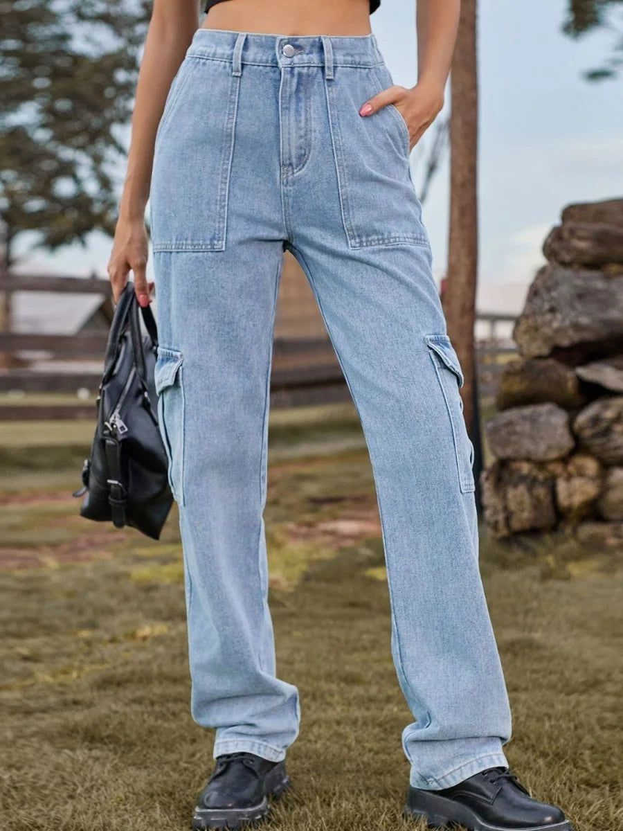 Light wash denim cargo pants with a regular fit and utility pockets, worn by a model.
