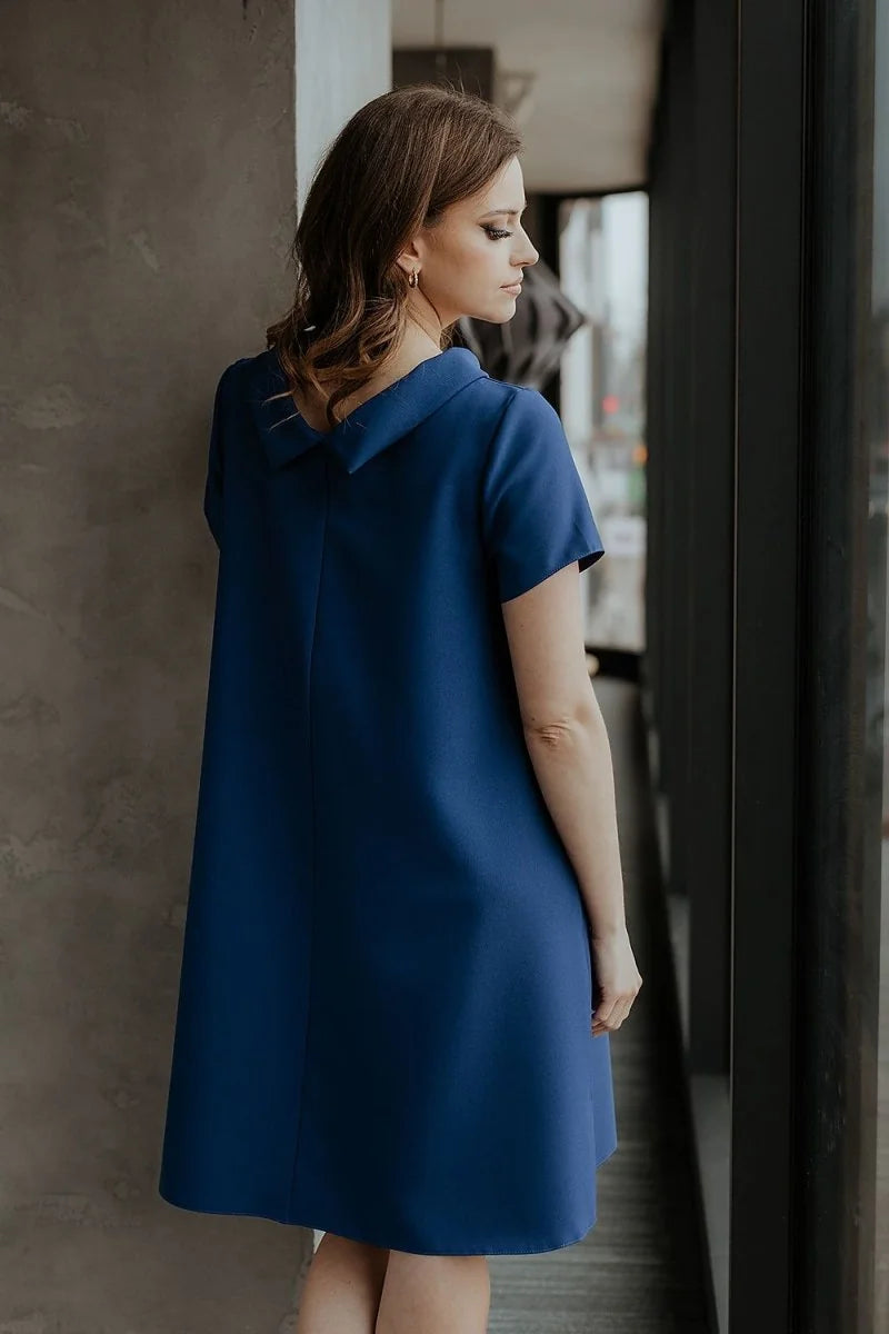 Loose-fit royal blue day dress with a Peter Pan collar, shown from the back on a model.