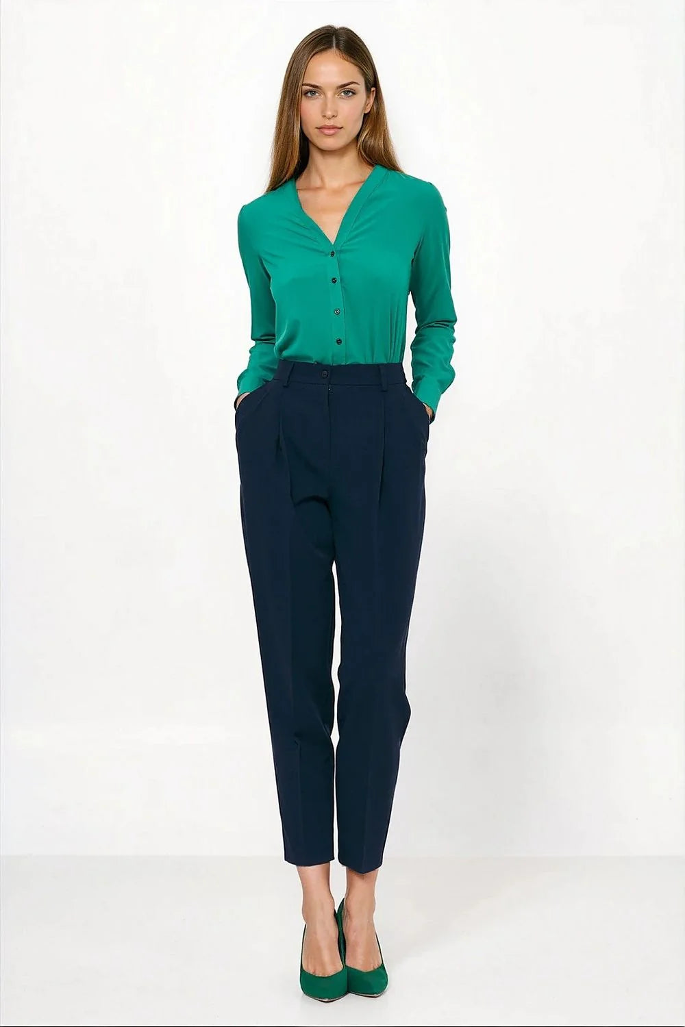 Navy blue pleated trousers with a regular fit, worn by a model with a green blouse and green heels.