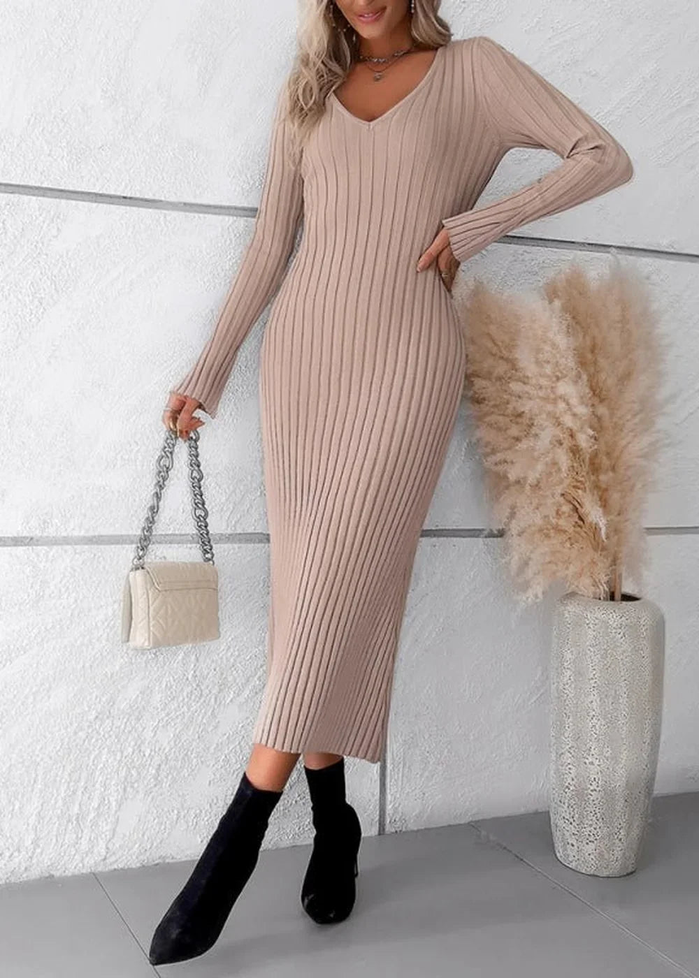 Khaki ribbed knit midi sweater dress with V-neck and long sleeves, worn by a model with a white quilted handbag.