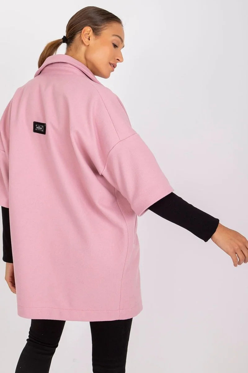 Loose fit pink jacket with black long-sleeve shirt underneath, shown from the back on a model.