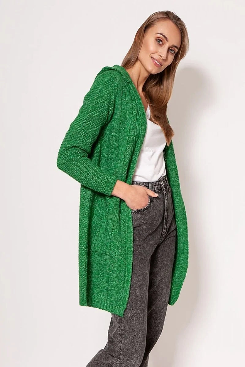 Green cable knit long cardigan with hood, featuring pockets and a white top and dark wash jeans on a model.
