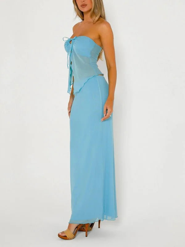 Light blue strapless top and maxi skirt set with tie detail, on model.