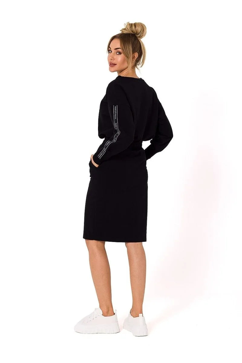 Black cotton-blend midi dress with sporty taping on the sleeves, worn by a model with white sneakers.