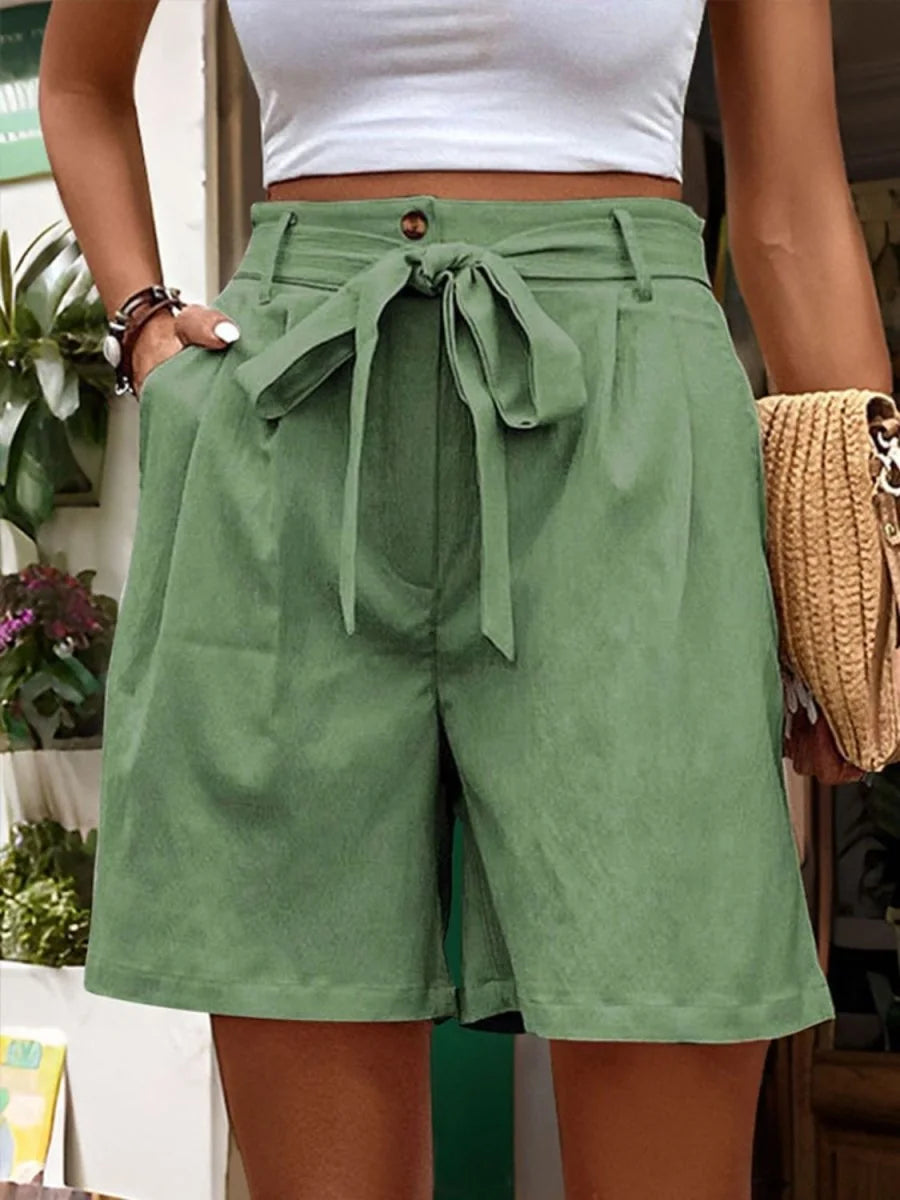 Light green polyester shorts with a tie waist and regular fit, shown on a model.