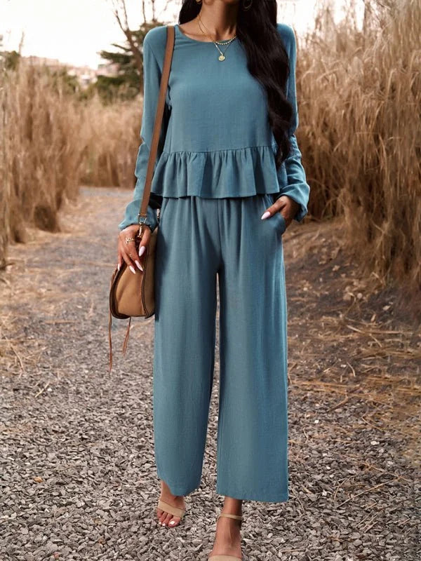 Teal linen-blend pant suit with ruffled peplum top and wide-leg pants, worn by a model.