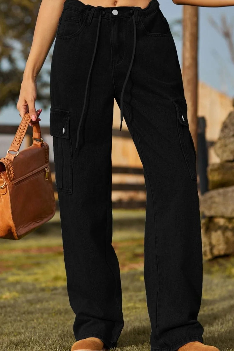 Black high-waisted cargo pants with drawstring waist and side pockets, on model.