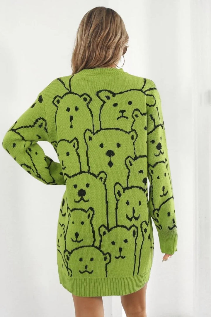 Lime green knitted sweater dress with a repeating black bear face pattern, long sleeves, and a crew neck.