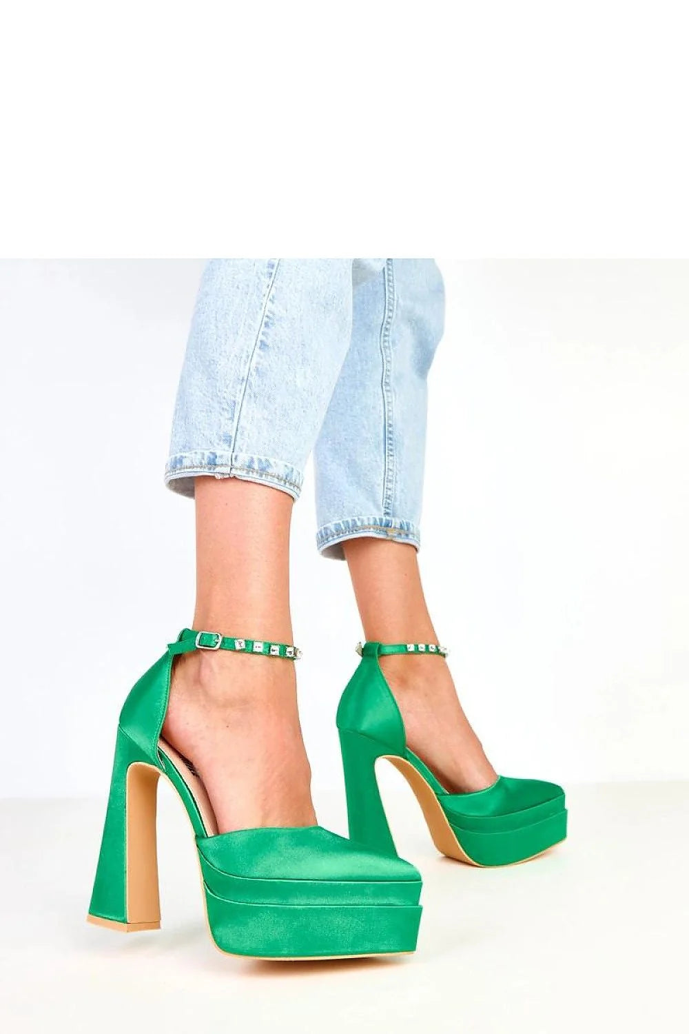 Emerald green satin platform heels with ankle straps and rhinestone embellishments.