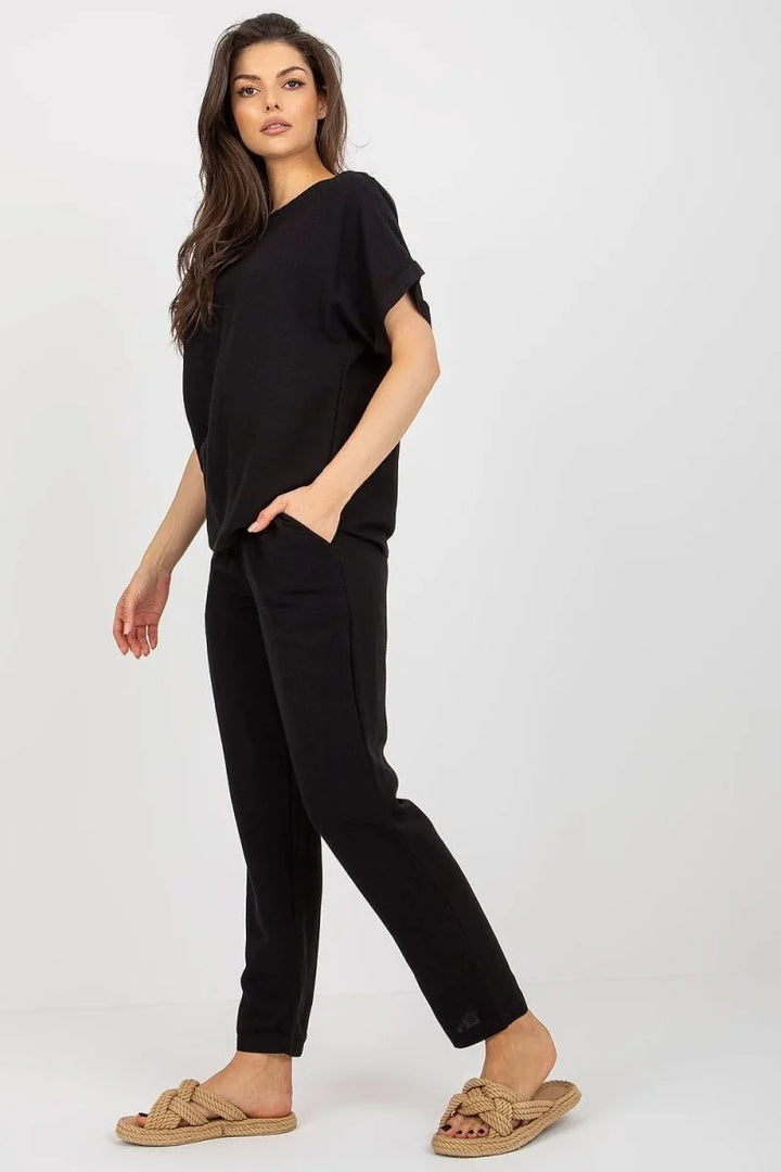 Black pants with a regular fit, made of cotton, linen, and viscose blend, shown on a model.