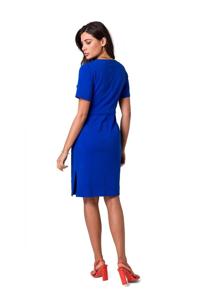 Cobalt blue fitted knit dress with short sleeves and a side slit, worn with coral block heels.