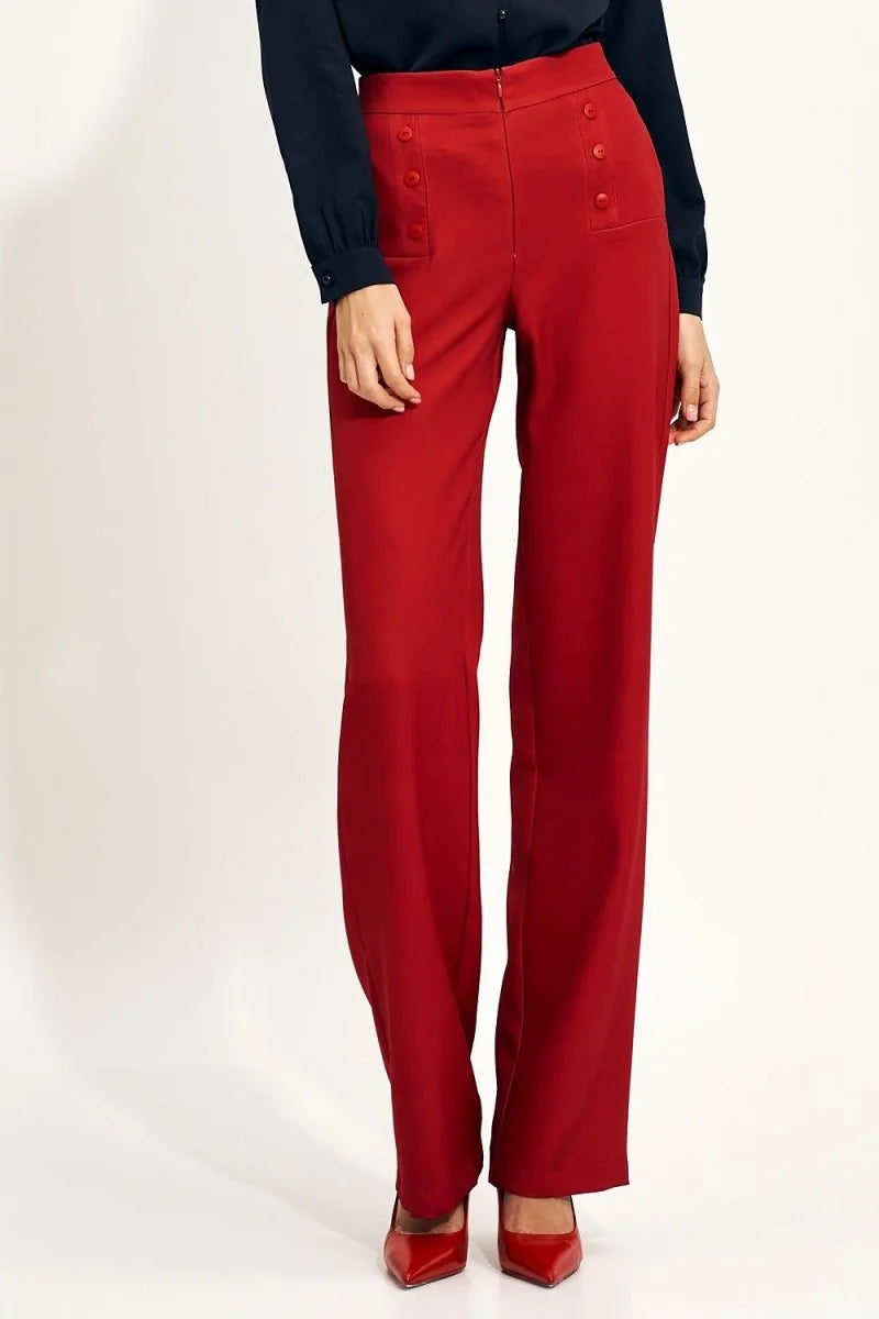 High-rise red wide-leg pants with decorative buttons on the front pockets, shown on a model.
