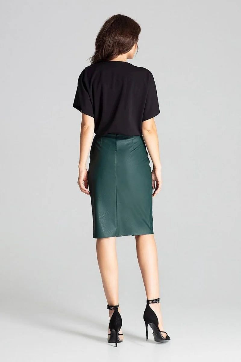 Back view of a woman wearing a dark green faux leather pencil skirt and black heels.